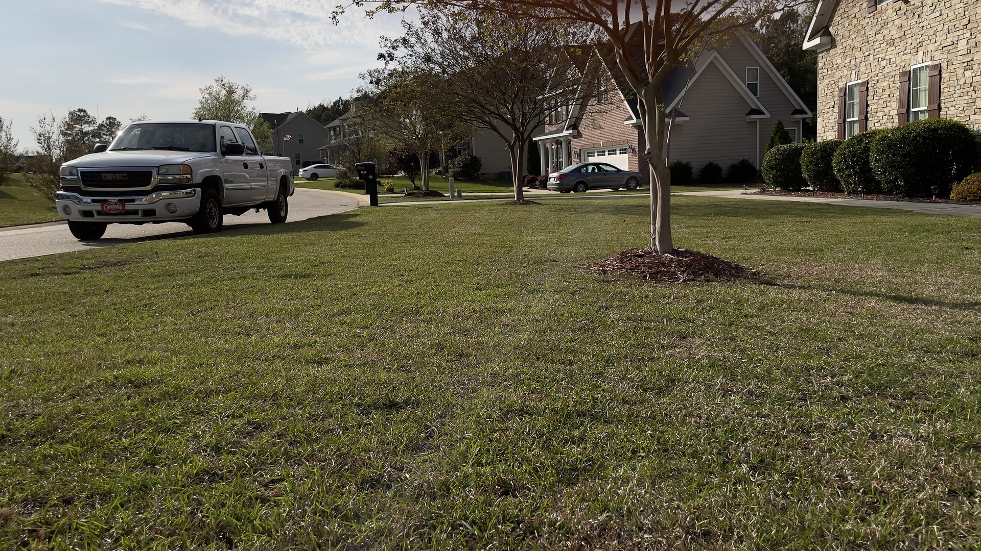 The Transitions truck at a freshly mowed lawn with a mulched tree ring